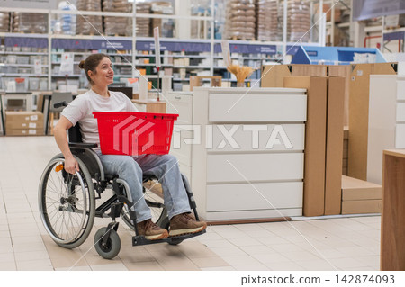 A Caucasian woman in a wheelchair buys furniture. A Caucasian woman in a wheelchair buys furniture. 142874093