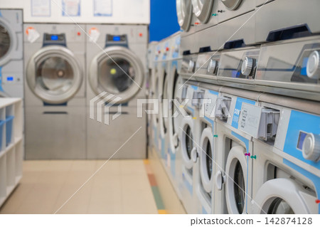 Public Express Laundry. Close-up of a large washing machine. Public Express Laundry. Close-up of a large washing machine. 142874128