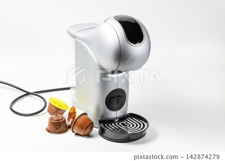 Modern White Espresso Coffee Machine, Side View of Coffee-Maker or Automatic Coffee Maker with Coffee capsule. Domestic Household Appliances, Capsule coffee machine. Modern White Espresso Coffee Machine, Side View of Coffee-Maker or Automatic Coffee Maker with Coffee capsule. Domestic Household Appliances, Capsule coffee machine. 142874279