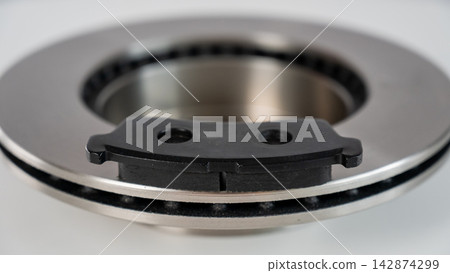 A close-up of new brake discs on a white background. A close-up of new brake discs on a white background. 142874299