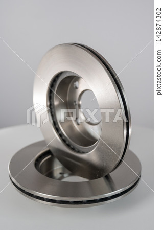 A close-up of new brake discs on a white background. A close-up of new brake discs on a white background. 142874302