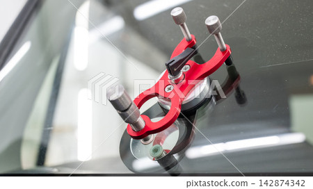 Repairing a chip on a car windshield. Repairing a chip on a car windshield. 142874342