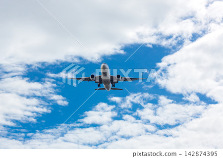 Airplane and sky, the plane is landing. Airplane take off on the blue sky Airplane and sky, the plane is landing. Airplane take off on the blue sky 142874395