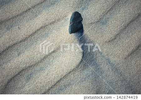 Close-up abstract of perfect wind ripple patterns in white sand dunes forming gentle waves Close-up abstract of perfect wind ripple patterns in white sand dunes forming gentle waves 142874419