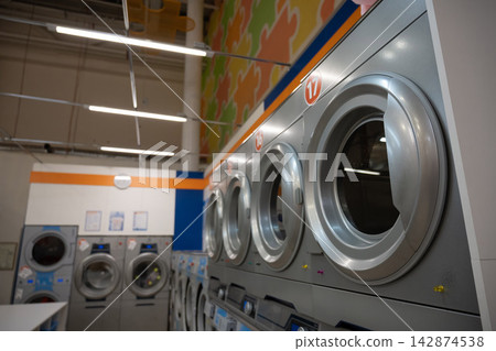 Public Express Laundry. Close-up of a large washing machine. Public Express Laundry. Close-up of a large washing machine. 142874538