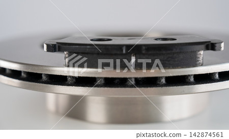 A close-up of new brake discs on a white background. A close-up of new brake discs on a white background. 142874561