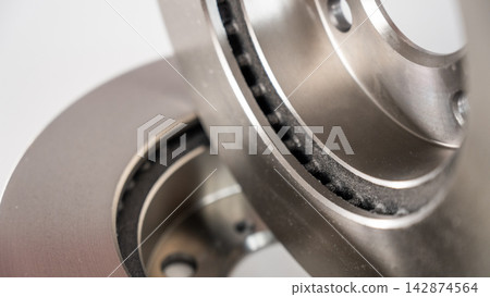 Close-up of car brake discs on white background.  142874564