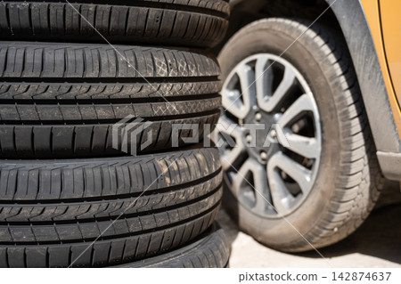 Changing car tires according to the season.  142874637