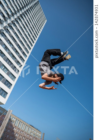 A girl jumps on a gymnastic trampoline. A girl jumps on a gymnastic trampoline. 142874931