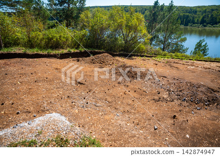 Archaeological excavation site near Tomskaya Pisanitsa in Siberia. Excavated soil layers represent research and discovery of ancient human history Archaeological excavation site near Tomskaya Pisanitsa in Siberia. Excavated soil layers represent research and discovery of ancient human history 142874947