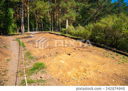Archaeological excavation site near Tomskaya Pisanitsa in Siberia. Excavated soil layers represent research and discovery of ancient human history Archaeological excavation site near Tomskaya Pisanitsa in Siberia. Excavated soil layers represent research and discovery of ancient human history 142874948
