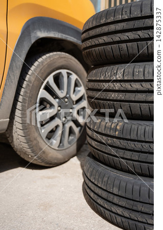 Changing car tires according to the season. Changing car tires according to the season. 142875337