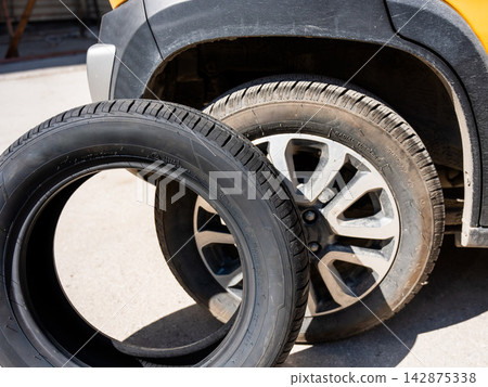 Changing car tires according to the season.  142875338