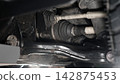 Car suspension and drive shaft. Structure of EV car spare parts. Such as Front or Rear suspension Shock absorber suspension Brake. Elements of the suspension and Chassis structure. Car service repair. 142875453