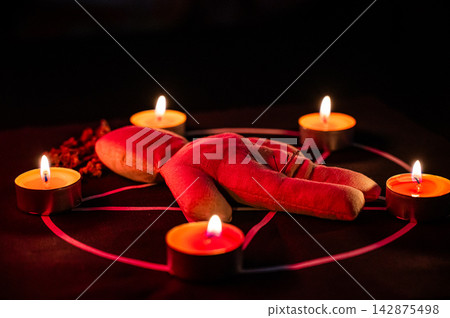 Voodoo doll on a pentagram. Witch spells. Voodoo doll on a pentagram. Witch spells. 142875498