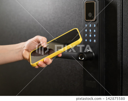 Modern smart door lock with digital keypad and keyless entry via smartphone. Modern smart door lock with digital keypad and keyless entry via smartphone. 142875580