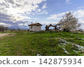 Small chapel in a rural snowy landscape, Bulgaria. 142875934