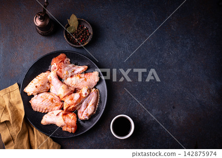 Raw uncooked chicken wings marinated Raw uncooked chicken wings marinated 142875974