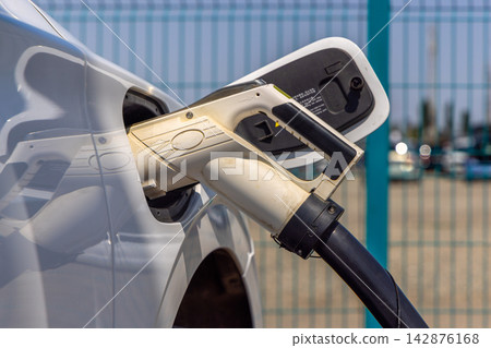 Close-up of Electric Vehicle Charging Connector in Use Close-up of Electric Vehicle Charging Connector in Use 142876168