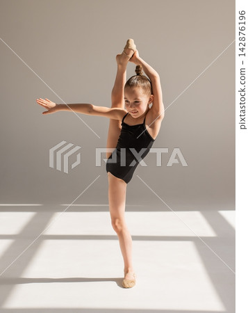 Little gymnast posing on a white background.  142876196