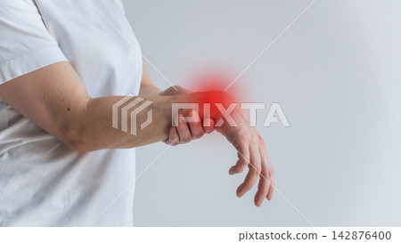A woman suffers from wrist pain. The source of the pain is depicted as a red spot. 142876400