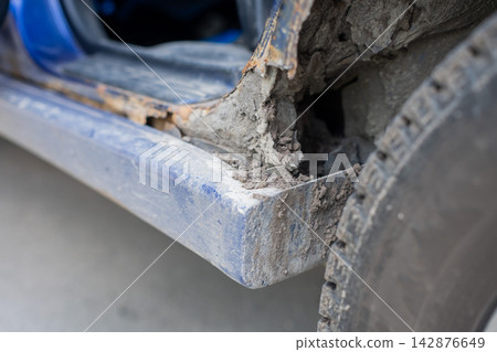 Close-up of a rusty car sill and arch. Close-up of a rusty car sill and arch. 142876649