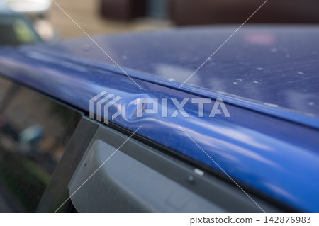 Close-up of a dent on a car body. Close-up of a dent on a car body. 142876983