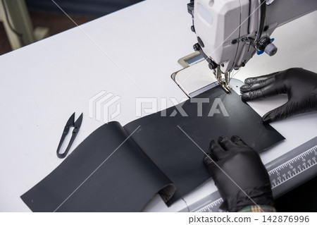 A close-up of a sewing machine at work. A close-up of a sewing machine at work. 142876996