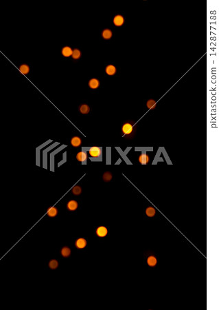 Warm orange bokeh lights on black background for abstract holiday and night photography Warm orange bokeh lights on black background for abstract holiday and night photography 142877188