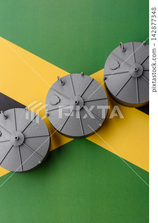 Liquefied gas storage tanks set against the Jamaica flag, concept of supply and distribution Liquefied gas storage tanks set against the Jamaica flag, concept of supply and distribution 142877348