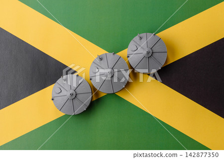 Liquefied gas storage tanks set against the Jamaica flag, concept of supply and distribution Liquefied gas storage tanks set against the Jamaica flag, concept of supply and distribution 142877350