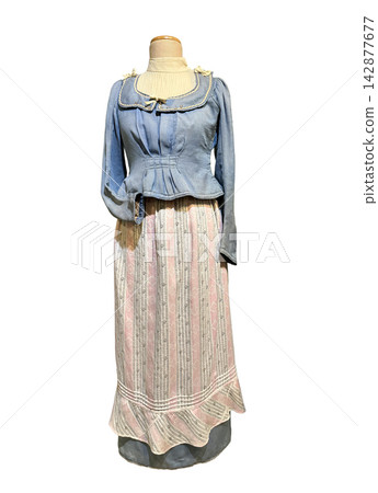 Antique folk-style two-piece outfit featuring a blue textured bodice with a wide collar and a long, pink-and-white striped skirt with a ruffled hem. Antique folk-style two-piece outfit featuring a blue textured bodice with a wide collar and a long, pink-and-white striped skirt with a ruffled hem. 142877677