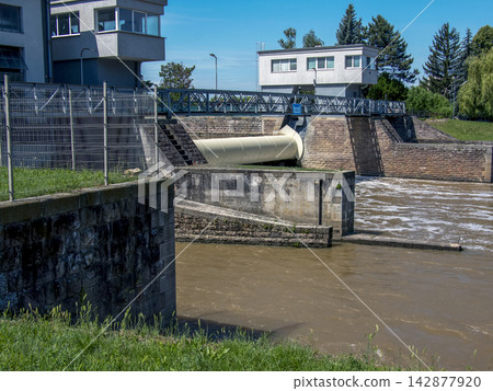 Water Flowing through a Small Hydroelectric Weir Water Flowing through a Small Hydroelectric Weir 142877920