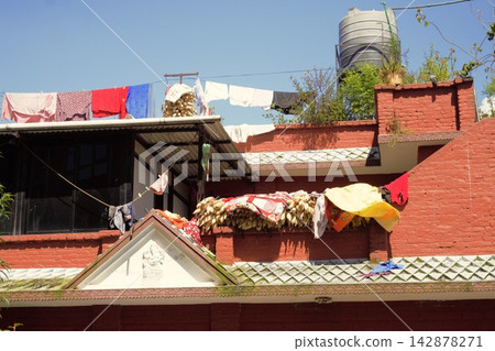 Corn drying on a veranda of a house in Changunarayan, Nepal. Corn drying on a veranda of a house in Changunarayan, Nepal. 142878271