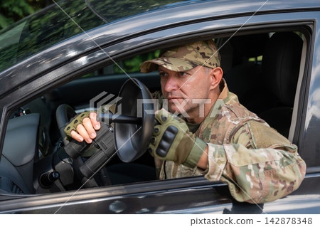 Intelligence operative performs covert radio monitoring and transmitter detection using specialized equipment during a secret mission. Intelligence operative performs covert radio monitoring and transmitter detection using specialized equipment during a secret mission. 142878348