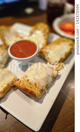 Cheesy Garlic Bread With Marinara Sauce and Sliced Tomatoes on a White Plate Cheesy Garlic Bread With Marinara Sauce and Sliced Tomatoes on a White Plate 142878504