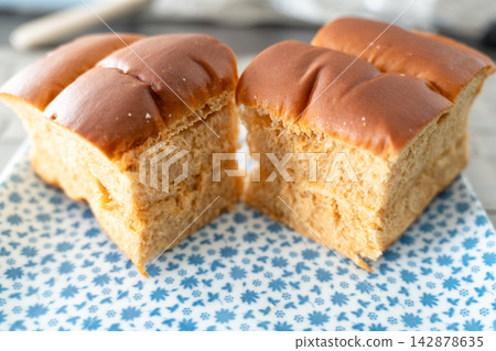 The appealing cross-section of a slice of bread cut in half, highlighting its fluffy texture. The appealing cross-section of a slice of bread cut in half, highlighting its fluffy texture. 142878635