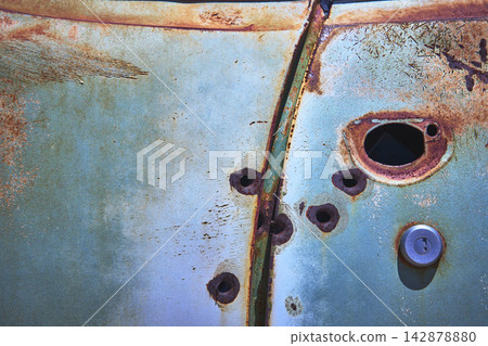 Abandoned Vehicle Detail With Rusted Metal Texture And Bullet Holes Abandoned Vehicle Detail With Rusted Metal Texture And Bullet Holes 142878880