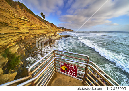 Sunset Cliffs Stairway Warning Sign and Ocean Waves in San Diego California Sunset Cliffs Stairway Warning Sign and Ocean Waves in San Diego California 142878995