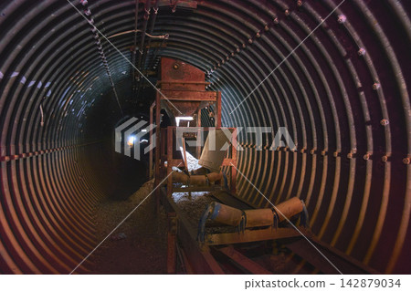 Abandoned Industrial Tunnel Conveyor and Mining Equipment in Mojave Desert Abandoned Industrial Tunnel Conveyor and Mining Equipment in Mojave Desert 142879034
