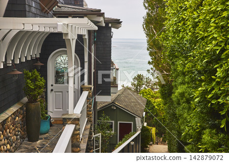 Laguna Beach California Elegant Coastal Home Entrance with Ocean View and Lush Greenery Laguna Beach California Elegant Coastal Home Entrance with Ocean View and Lush Greenery 142879072