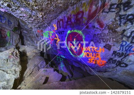 Graffiti Art and Blacklight Glow Inside Cowboy Canyon Cave in Nevada Graffiti Art and Blacklight Glow Inside Cowboy Canyon Cave in Nevada 142879151