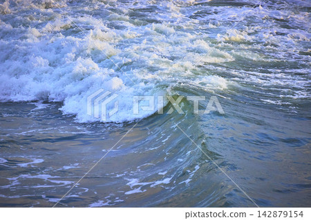 Ocean Wave Curl and Surf Close Up with Vibrant Blue Water Ocean Wave Curl and Surf Close Up with Vibrant Blue Water 142879154