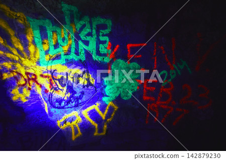 Glowing Graffiti Art in Cowboy Canyon Cave Under Blacklight in Vibrant Neon Colors Glowing Graffiti Art in Cowboy Canyon Cave Under Blacklight in Vibrant Neon Colors 142879230