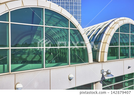 Modern Arched Glass Facade and Urban Skyline with Blue Sky in San Diego Modern Arched Glass Facade and Urban Skyline with Blue Sky in San Diego 142879407