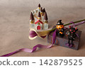 Flowers and decorations create a Halloween theme. 142879525