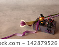 Flowers and decorations create a Halloween theme. 142879526