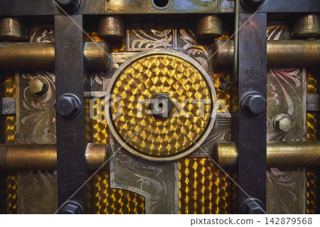 Close Up Ornate Vault Door Mechanism and Engraved Metalwork Detail Close Up Ornate Vault Door Mechanism and Engraved Metalwork Detail 142879568