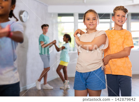 Active preteen children practicing Ballroom dances in pairs in training hall Active preteen children practicing Ballroom dances in pairs in training hall 142879642
