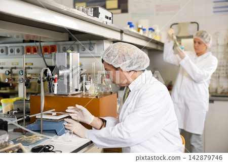 Confident man scientist working in research laboratory Confident man scientist working in research laboratory 142879746